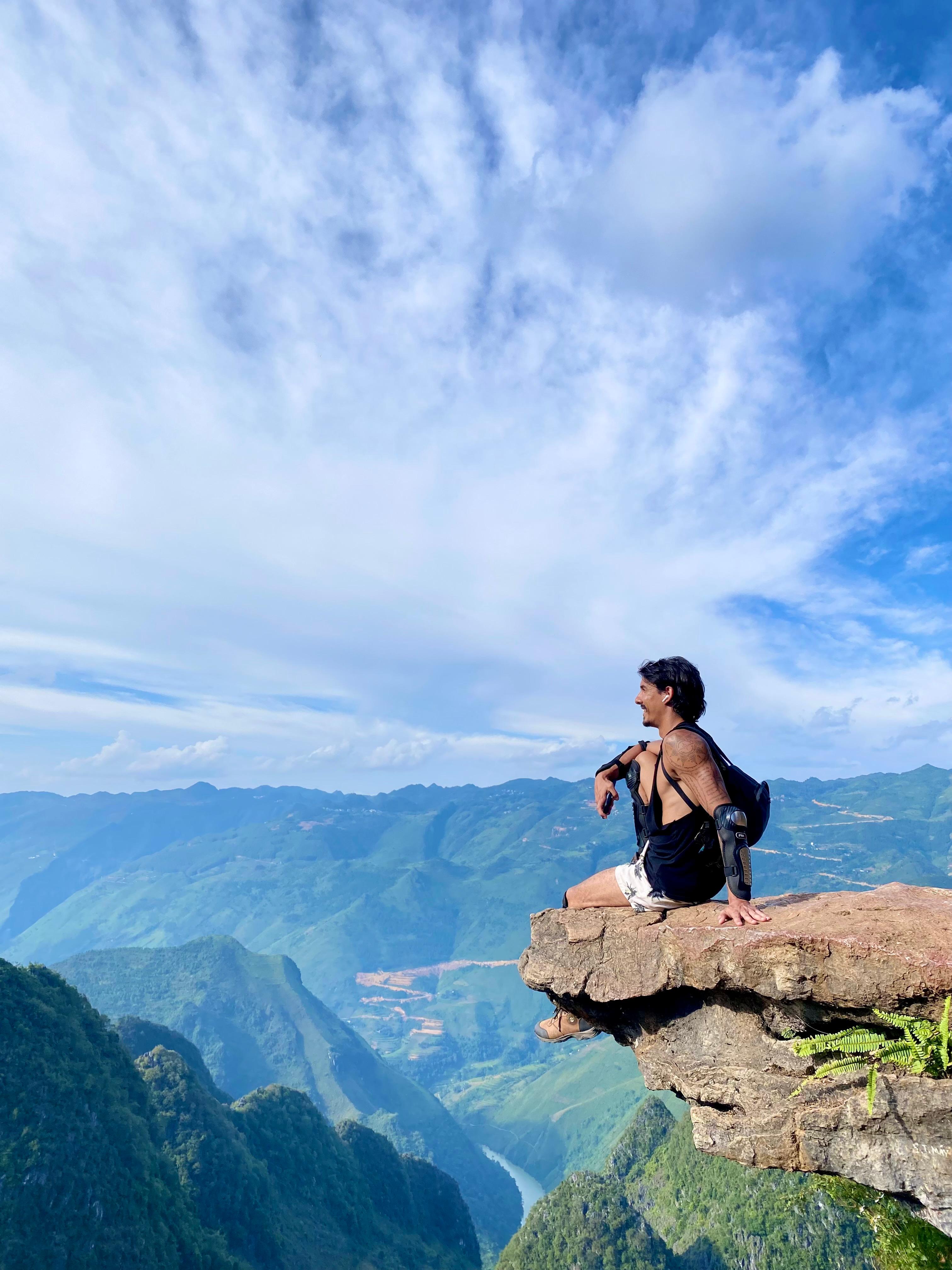 Ken sitting on a cliff edge